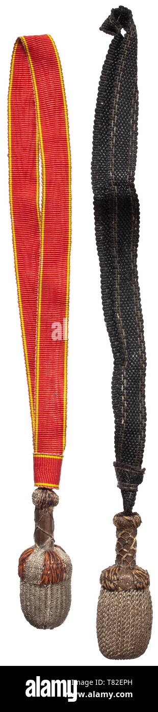 A Russian St. Anna sword knot for a shashka Circa 1910. Silver wire winding with alternating orange and black wool threads. Strap of watered silk rep. Total length 31 cm. Good condition with slight signs of usage. Comes with a sword knot for a Russian dragoon shashka, circa 1910. Strap of black replacement material. Total length 34 cm. historic, historical, 20th century, Additional-Rights-Clearance-Info-Not-Available Stock Photo
