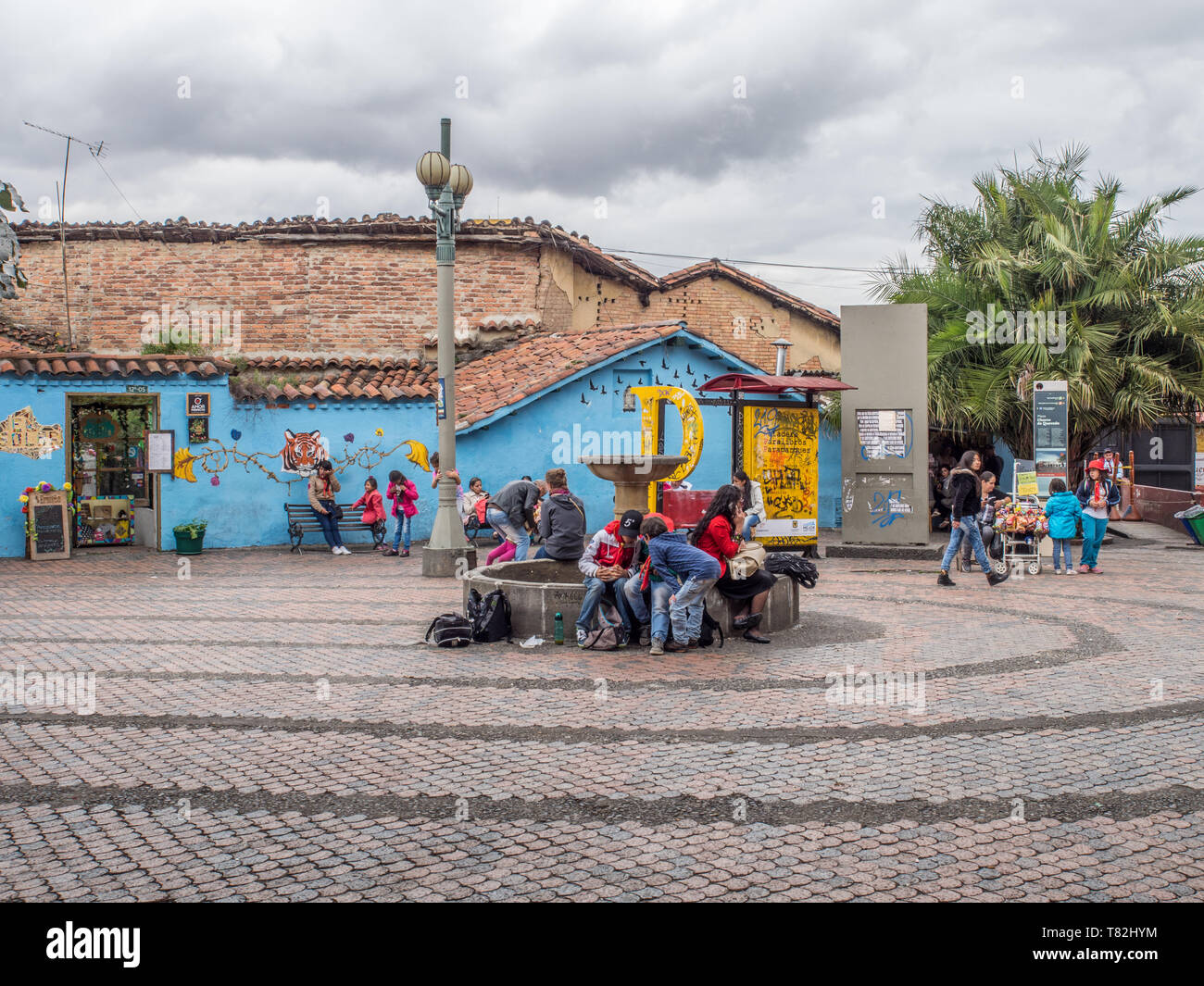 Bogota, Colombia - May 01, 2016: People sitting on the square with a fountain and colonial buildings. South America. Stock Photo