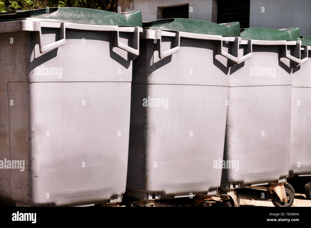 Large garbage containers, trash dumpsters and bins standing in row