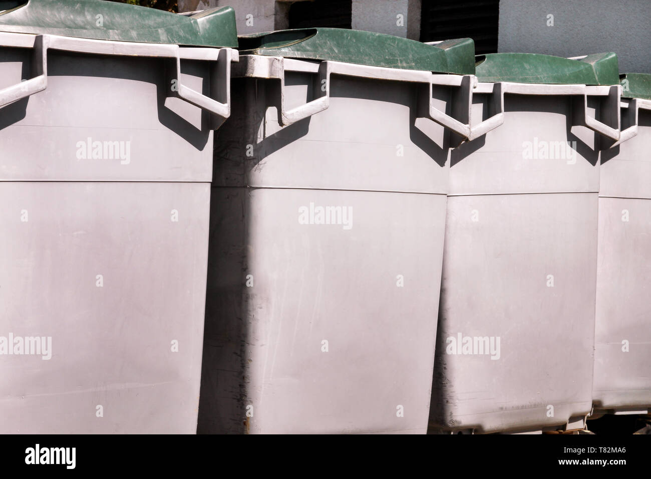 Large garbage containers, trash dumpsters and bins standing in row