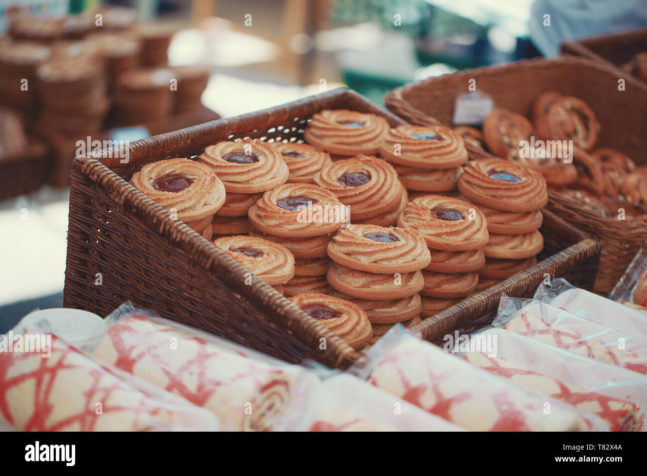 Strawberry biscuits on market table at spring, color graded, cinematic style, outdoors Stock Photo