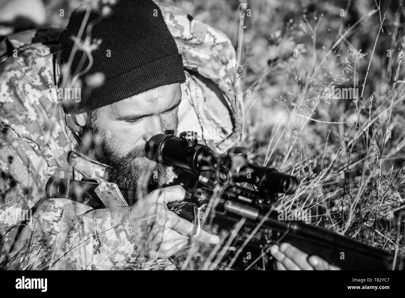 Army forces. Camouflage. Military uniform fashion. Bearded man hunter. Hunting skills and weapon equipment. How turn hunting into hobby. Man hunter with rifle gun. Boot camp. I got my eye on you. Stock Photo
