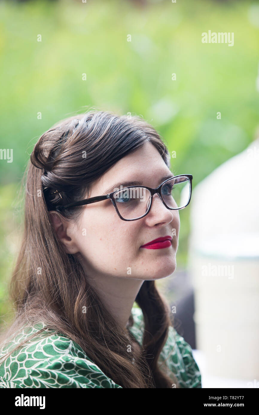Close-up portrait of young woman wearing red lipstick & glasses, Black Country Living Museum UK, 1940's wartime summer weekend. Stock Photo
