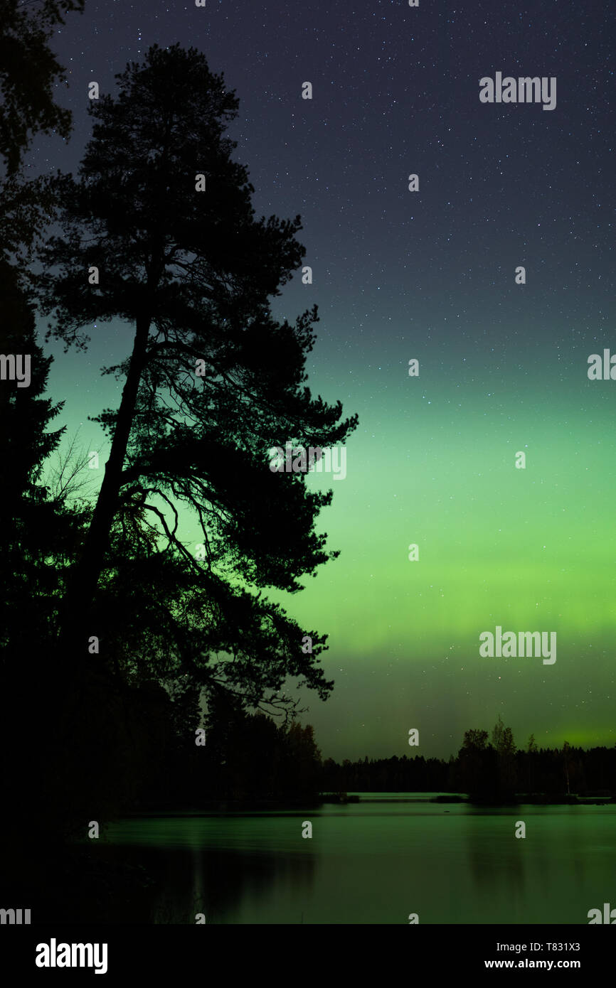 Beautiful northern lights over lake Stock Photo - Alamy
