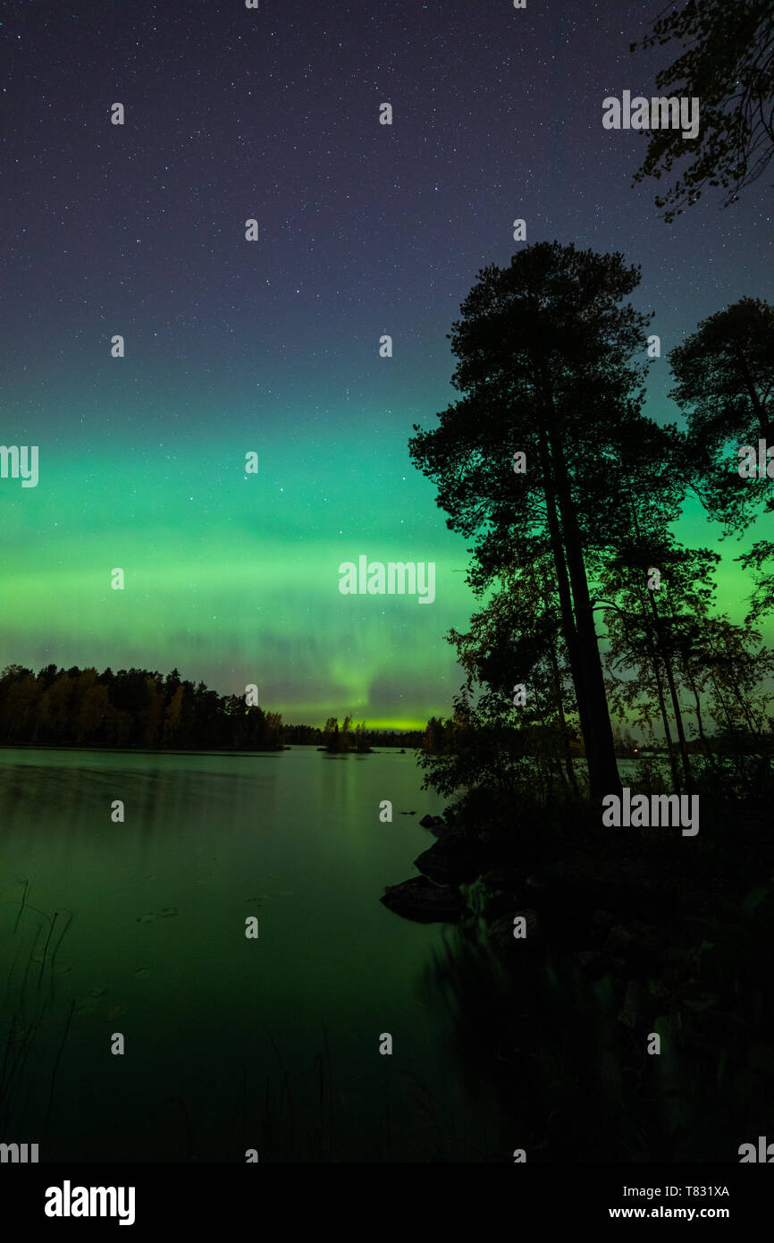 Beautiful northern lights over lake Stock Photo - Alamy