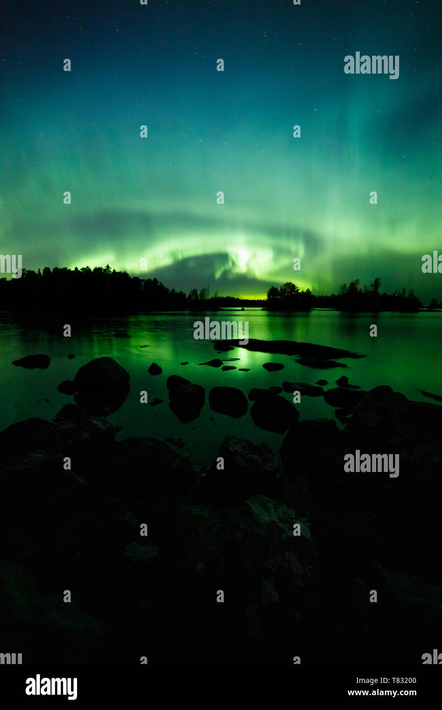 Beautiful northern lights over lake Stock Photo - Alamy