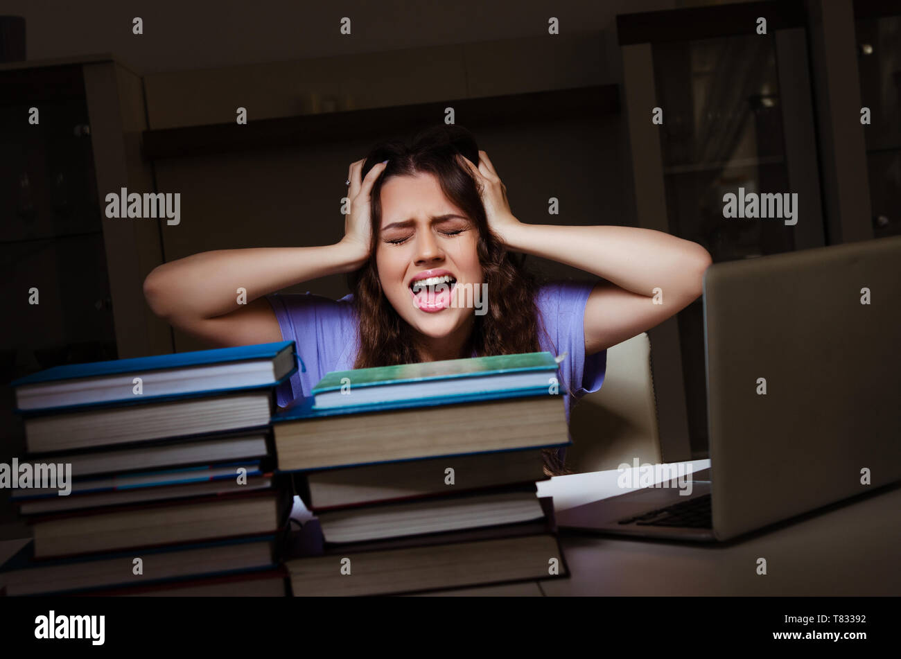 Young female student preparing for exams late at home Stock Photo - Alamy