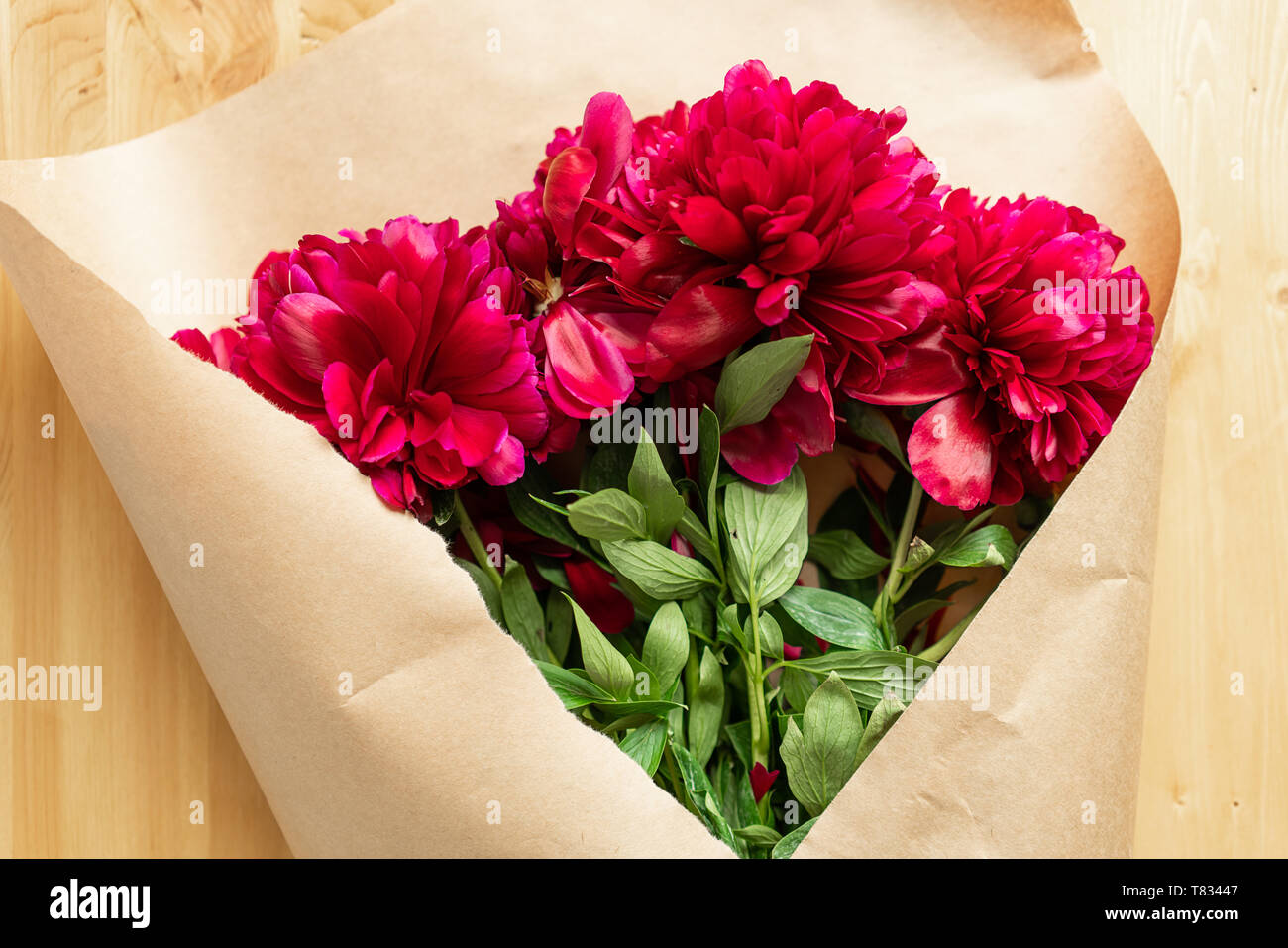 Peony background. Fuchsia, pink and white peonies on wooden table with ...