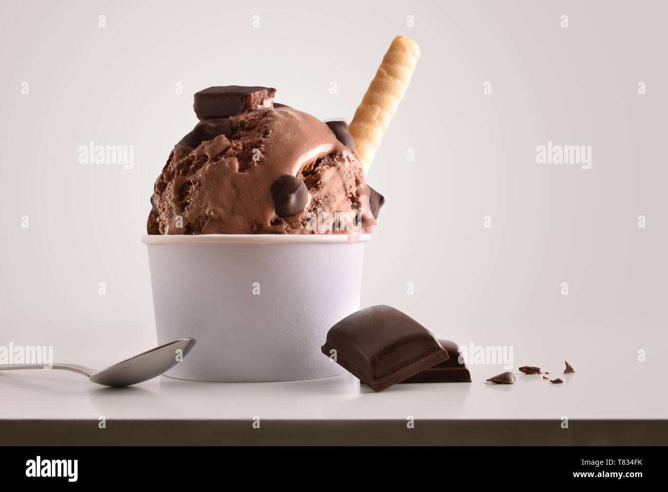 https://c8.alamy.com/comp/T834FK/composition-of-chocolate-ice-cream-ball-in-paper-cup-on-white-table-with-products-of-ornament-and-elaboration-isolated-background-horizontal-composit-T834FK.jpg