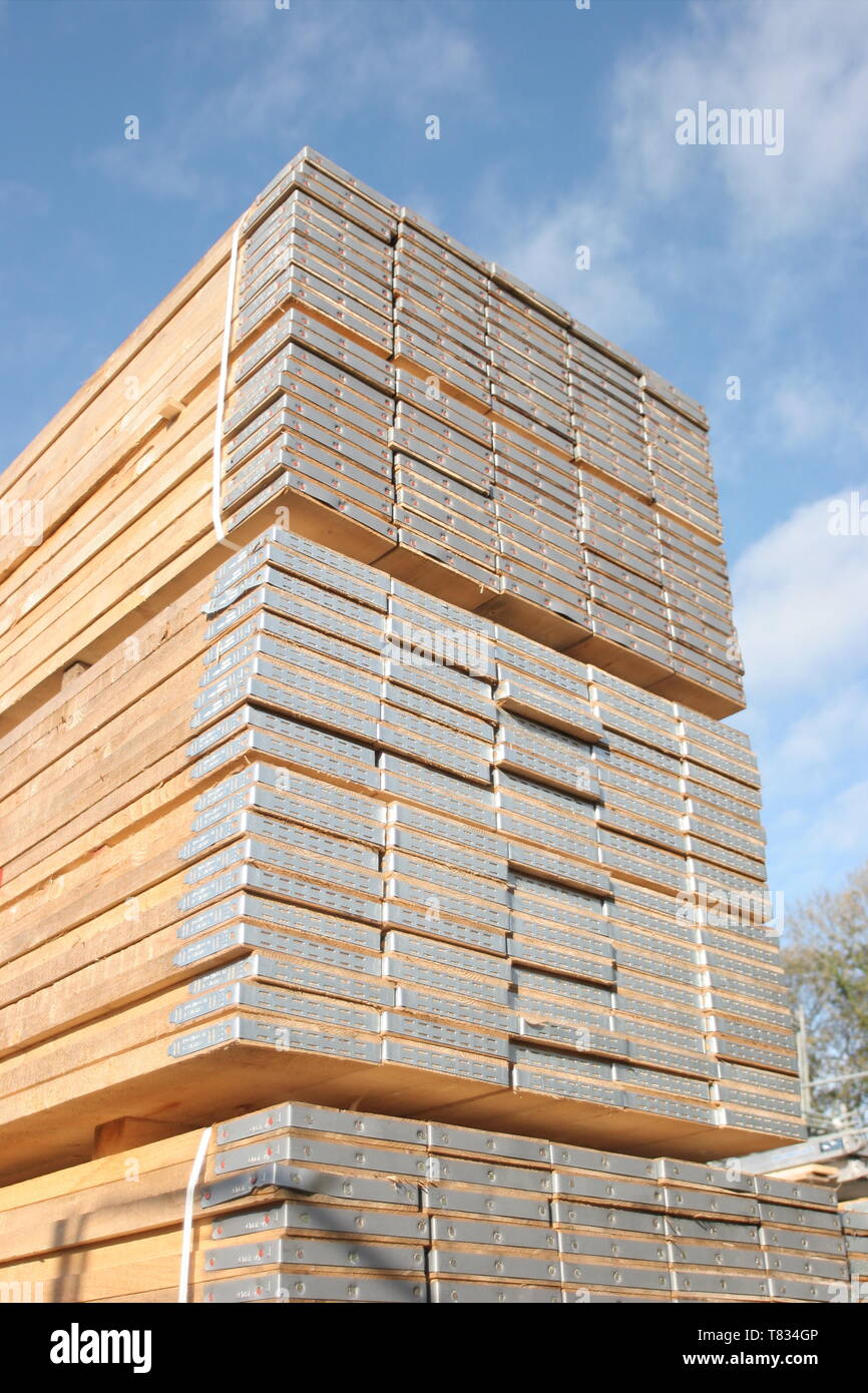 Stacks of new scaffolding boards in a London Builders Merchant's yard. Photographed on a sunny, summer day. Stock Photo