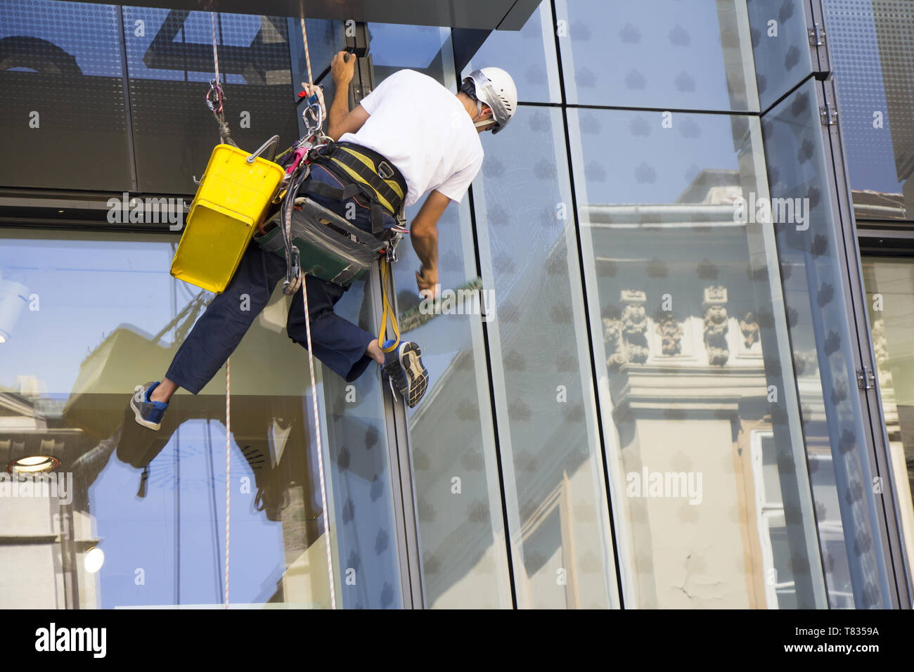 Window washer cleaning the windows of shopping center Stock Photo