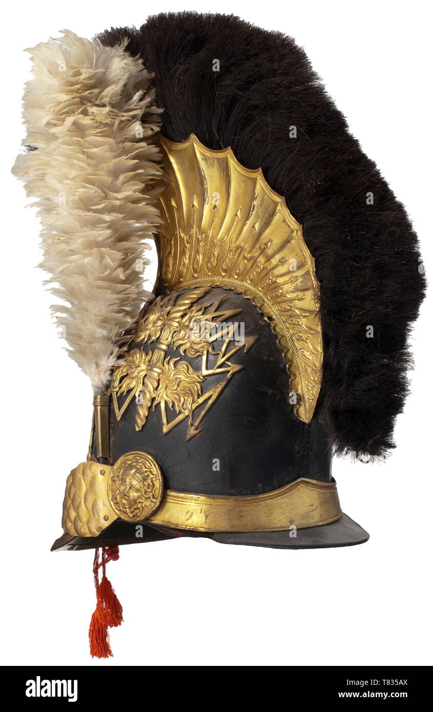 A helmet M 1814 for officers of the guard gendarmerie Black leather body, gilt fittings, black horsehair crest (replaced), stamped and gilt emblem with the crowned French coat of arms, thunderbolts and inscription scroll 'Quo jubet iratus Jupiter'. Velvet-backed chinscales on Gorgon heads, liner damaged. Small flaw at neck guard, white feather plume. The gendarmes of the guard belonged to the corps of the royal house. They were formed during the First Restoration in 1814 and were dissolved during the Second Restoration. Only a gendarme company of, Additional-Rights-Clearance-Info-Not-Available Stock Photo