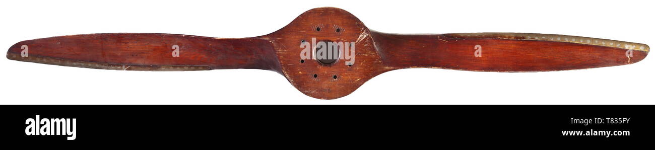 A two-blade propeller Circa 1920, made of multi-layered walnut wood. The tapering hub marked 'bky' as well as 'D1780' and '6004143'(?). Eight bolt holes for mounting the propeller. Propeller ends with multi-riveted brass protection. Light usage and wear marks, origin presumably abroad. Hub diameter 25.5 cm, total length of propeller 180 cm. historic, historical, troop, troops, armed forces, military, militaria, army, wing, group, air force, air forces, 20th century, Editorial-Use-Only Stock Photo