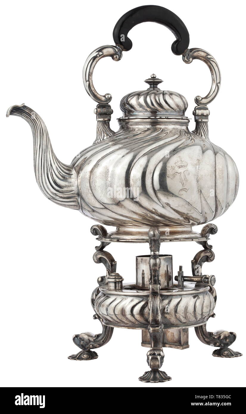 Ludwig II of Bavaria (1845 - 1886) - a tea-pot with a warmer Circa 1870. Round body flattened on both sides, gadrooned, 800 silver, on the bottom a mark of fineness with crescent moon and crown as well as a mark of the court jeweller 'Ed. Wollenweber', tubular spout, hinged lid, folding volute handle with blackened wood grip, crowned royal monogram and the Bavarian coat of arms. Corresponding silver warmer with holder for the burner, also decorated in a Neo-Baroque style. Signs of age and use. Total height circa 35 cm. Total weight circa 2,400 g., Additional-Rights-Clearance-Info-Not-Available Stock Photo