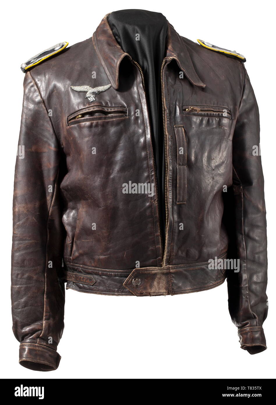 A leather jacket for a fighter pilot in the rank of an NCO Brown leather with looped shoulder boards, zipper ('Ritsch'), 'PRYM' press buttons, brown lining, hand-embroidered officer's eagle sewn on. A few flaws and repairs. Clearly worn, privately purchased leather jacket for a fighter pilot. historic, historical, Air Force, branch of service, branches of service, armed service, armed services, military, militaria, air forces, object, objects, stills, clipping, clippings, cut out, cut-out, cut-outs, 20th century, Editorial-Use-Only Stock Photo