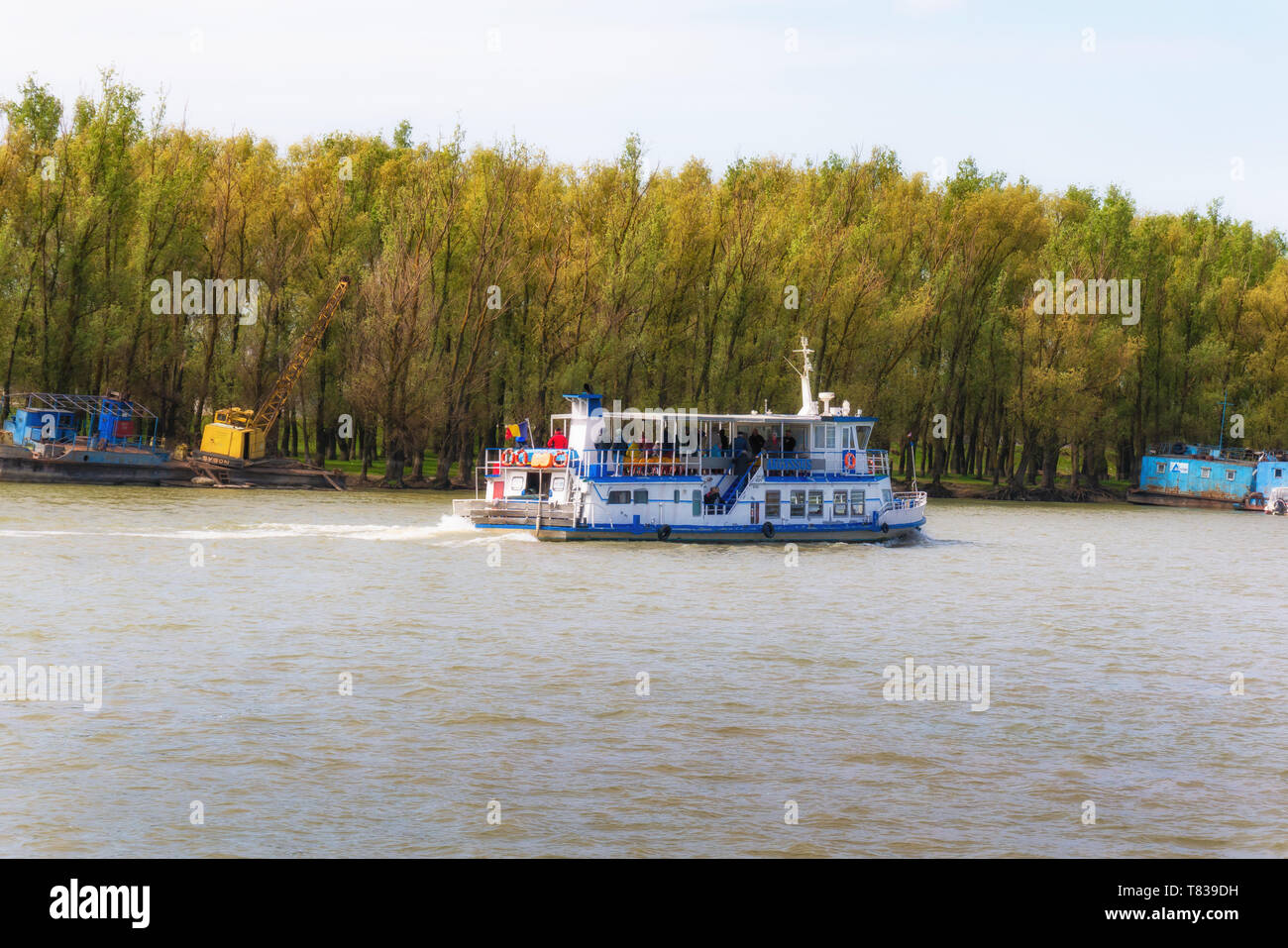 The Danube Delta Biosphere Reserve, Romania. April 20, 2019. A small cruise ship travels along the river. Stock Photo
