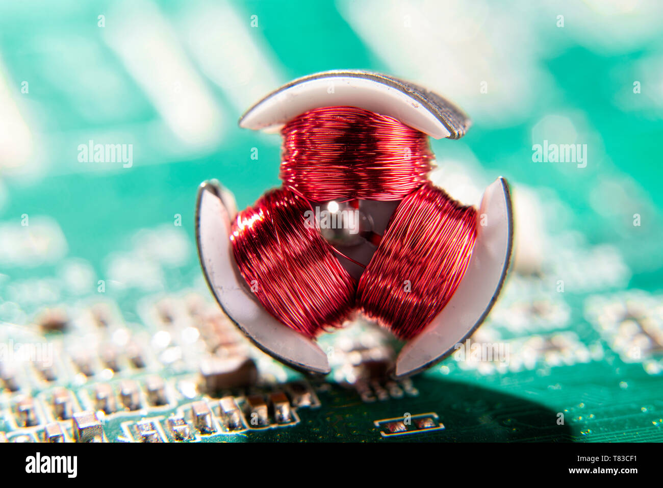 Red coils of an electric motor with circuit board Stock Photo