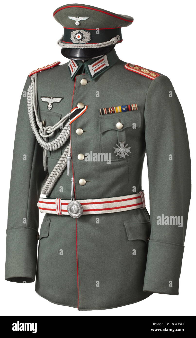 A uniform of an army bandmaster A visor cap for officers, red piping, aluminium cockade and eagle, hand-embroidered oak leaves. Brown-orange coloured liner with the maker's identification "Deutsche Wertarbeit, Sonderklasse". Improved field tunic of gabardine in officer's quality. Button-on collar, the inside pocket with the sewn tailor's label "Averbeck & Bröskamp, Berlin" and handwritten inscription "Unteroffz. Hagen Nr. 4078 Okt. 1934". Sewn-on shoulder boards for army bandmasters with red interweaves and backing. Officer's eagle, lanyard, appl, Additional-Rights-Clearance-Info-Not-Available Stock Photo