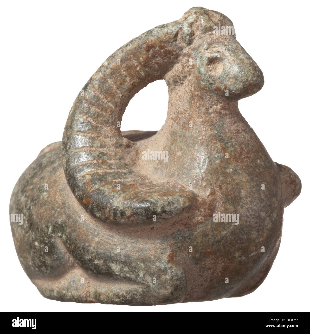 A North Syrian idol of an ibex 4th millenium BC. Stylised, lying ibex of greenish stone with widely protruding openwork horns. Length circa 5 cm. Provenance: Böblingen private collection, 1970s. historic, historical, ancient world, Additional-Rights-Clearance-Info-Not-Available Stock Photo