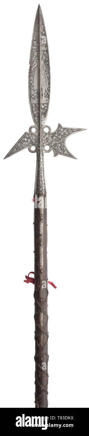 A splendid German halberd Circa 1580. Broad spike with pronounced central ridge, concave axe blade and fluke with several perforations, conically tapering, facetted socket with four long side straps. One edge of the spike jagged. The blade of the halberd with profuse black etchings of a male and female figure in contemporary attire between intricate scrolling leaves on dotted ground. Original shaft with remains of fabric tassels and original leather wrapping attached by nails. Shoe missing. Length 231 cm. historic, historical, pole weapon, weapon, Additional-Rights-Clearance-Info-Not-Available Stock Photo