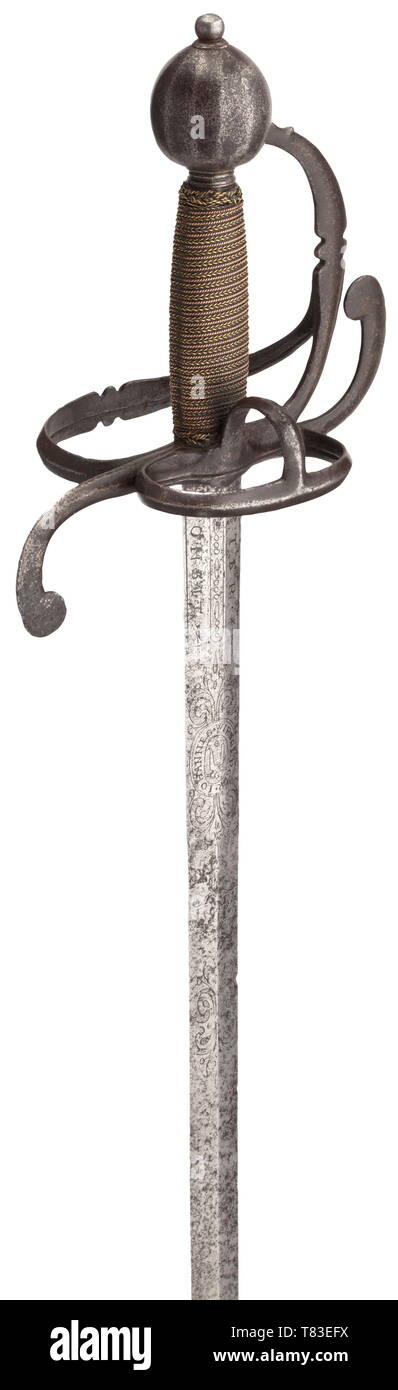 A German campaign sword Circa 1630. Richly etched blade of diamond section, the obverse with the motto 'SOLI DEO GLORIA', surmounting a medallion signed 'Iohannes Wirsberger' and a Christ monogram 'IHS', on the reverse another medallion depicting smith pliers and signature 'Iohannes Wirsberger', each set between floral decoration. On both sides of the base of the blade the additional signature 'Peter Monsit' and 'Me Fecit Solingen'. Chiselled knuckle-bow hilt (guard plates missing), grip elaborately bound with copper and brass wire and with Turk', Additional-Rights-Clearance-Info-Not-Available Stock Photo