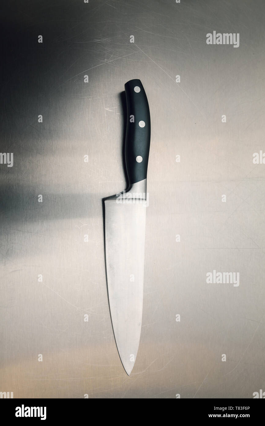 kitchen knife on a metal surface, close up Stock Photo