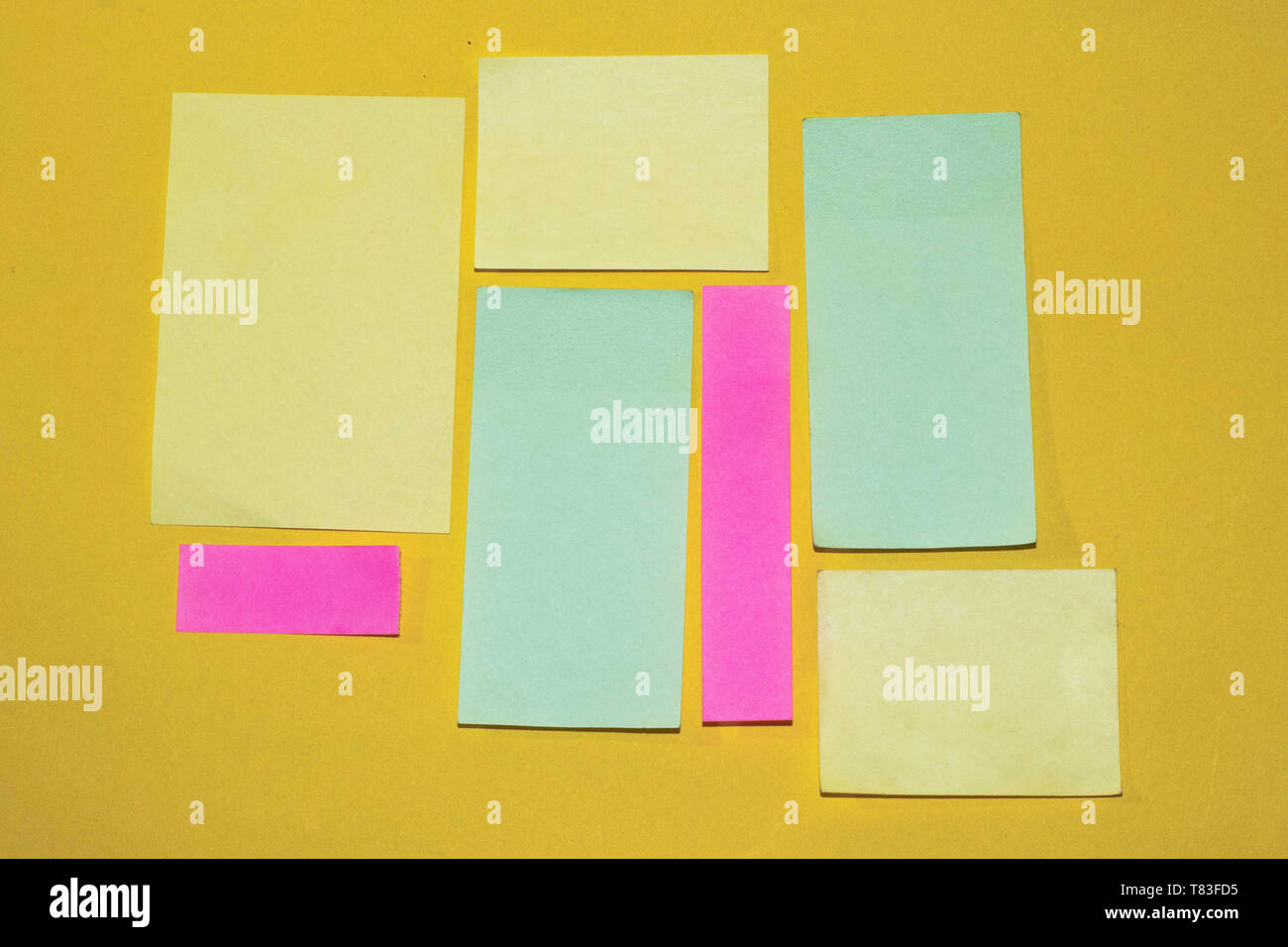 Sticky notes with different size and color on a yellow background. Ready  for message and notes Stock Photo - Alamy