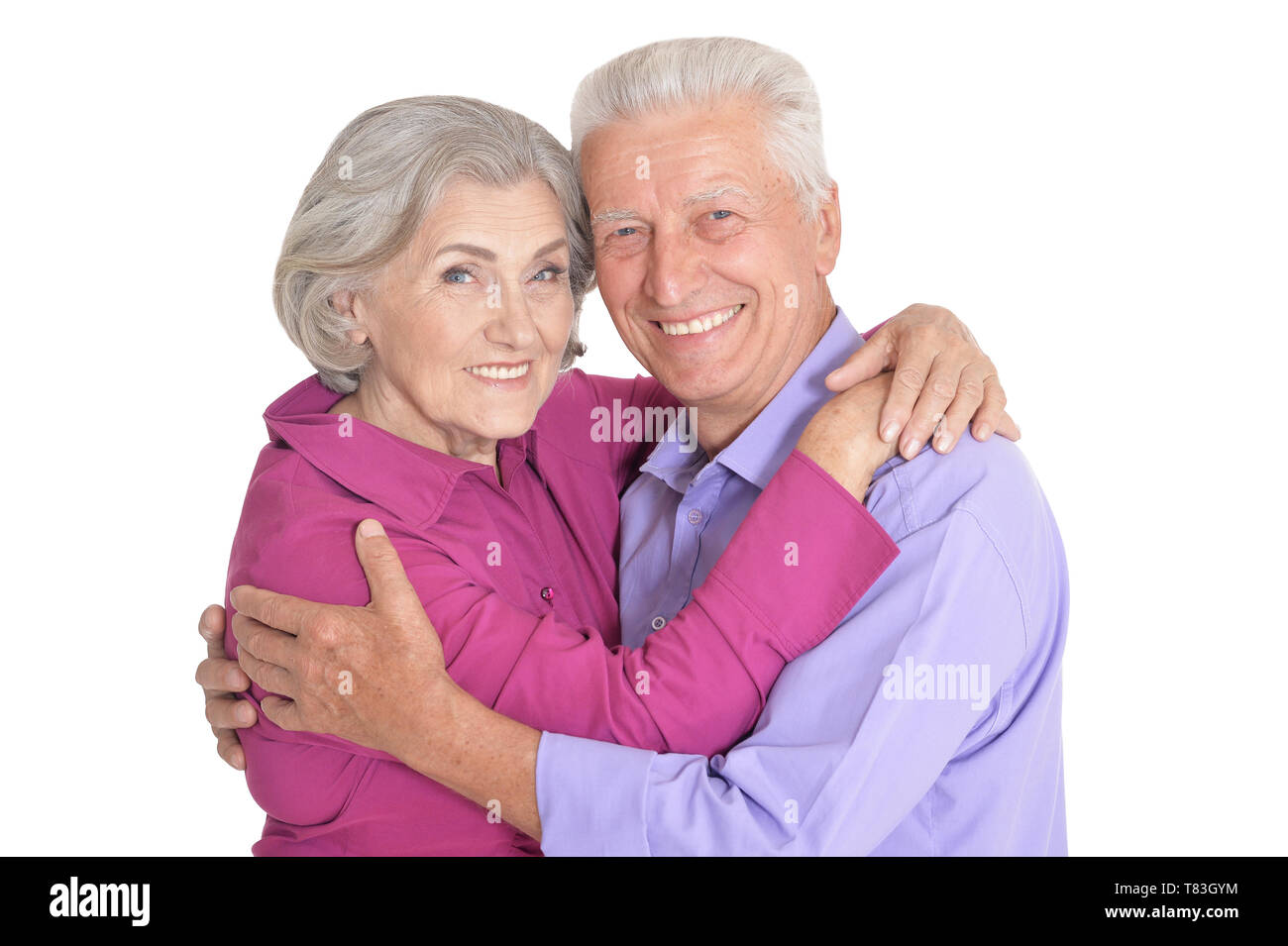 Portrait of happy senior couple posing on white background Stock Photo