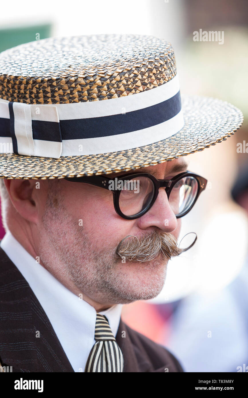 Close up portrait of smart man with fancy, grey handlebar moustache & glasses, wearing straw boater, Black Country Museum 1940's wartime event. Stock Photo