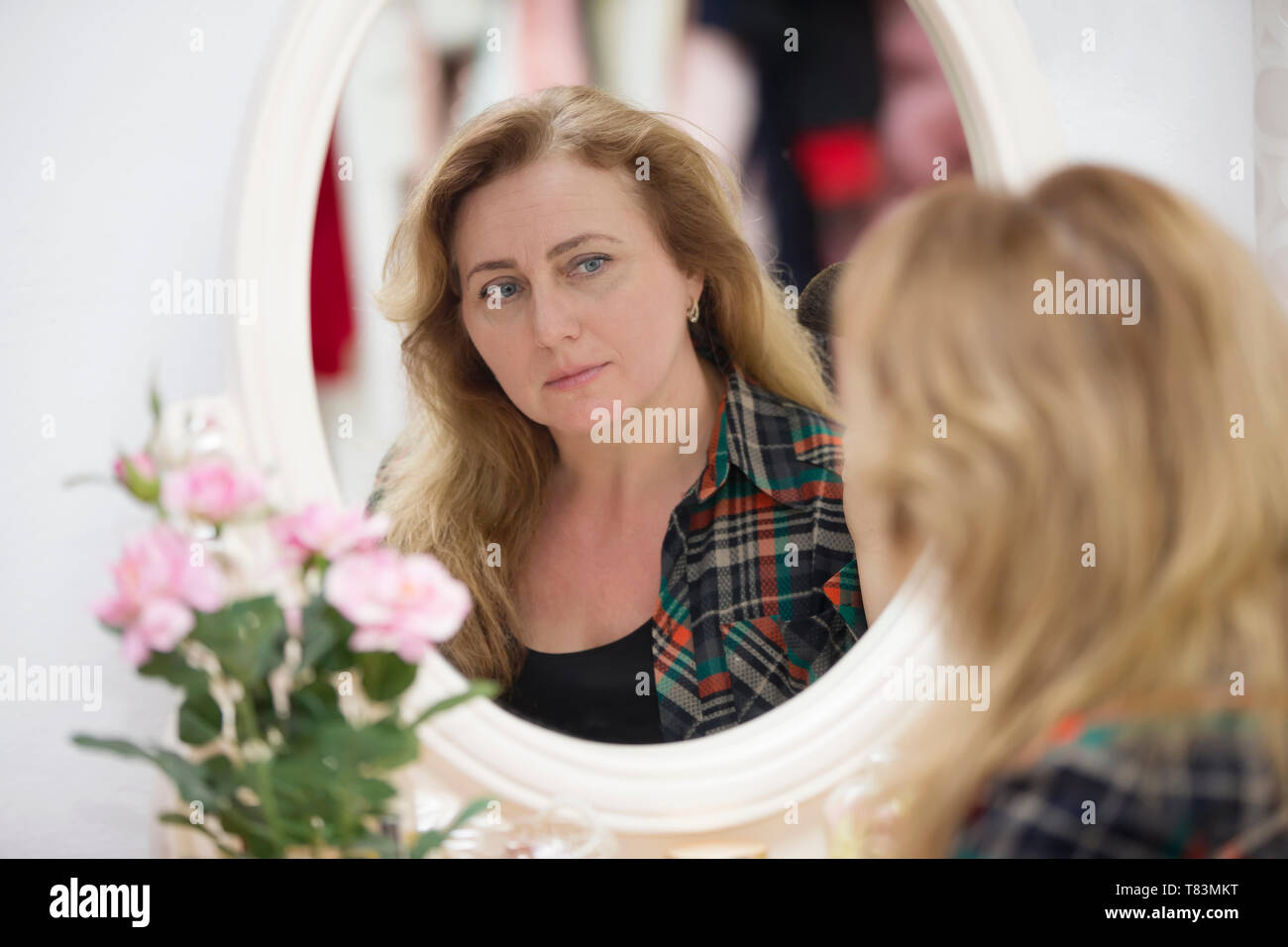 Mature woman examining skin hi-res stock photography and images - Alamy