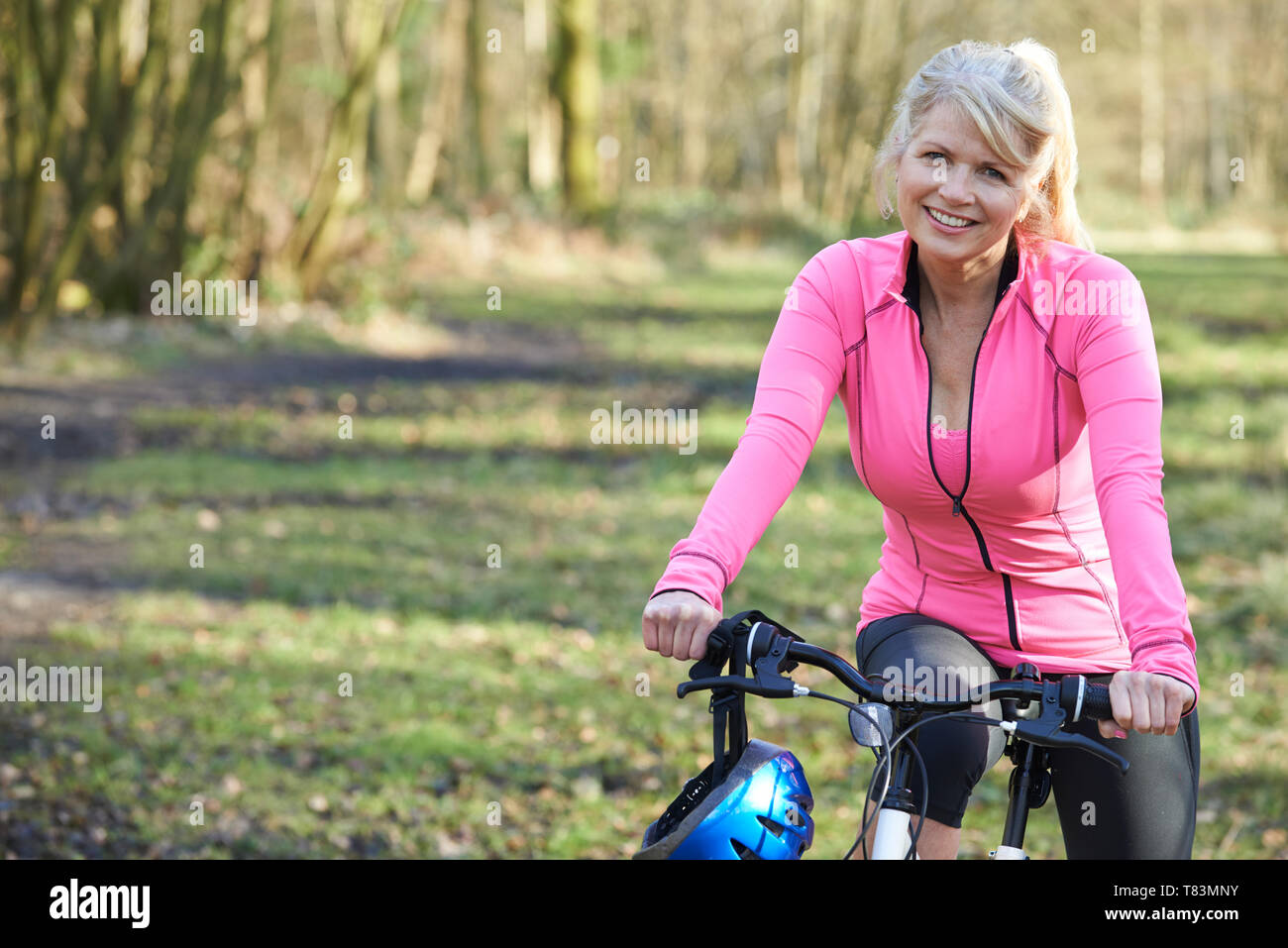 Portrait Of Mature Woman On Cycle Ride In Countryside Stock Photo