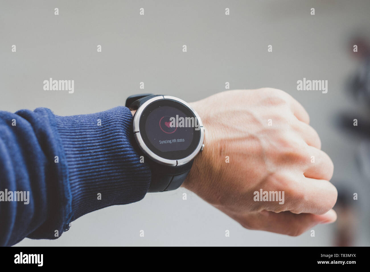 Runner checking progress on smart watch. Fit male runner exercise training Stock Photo