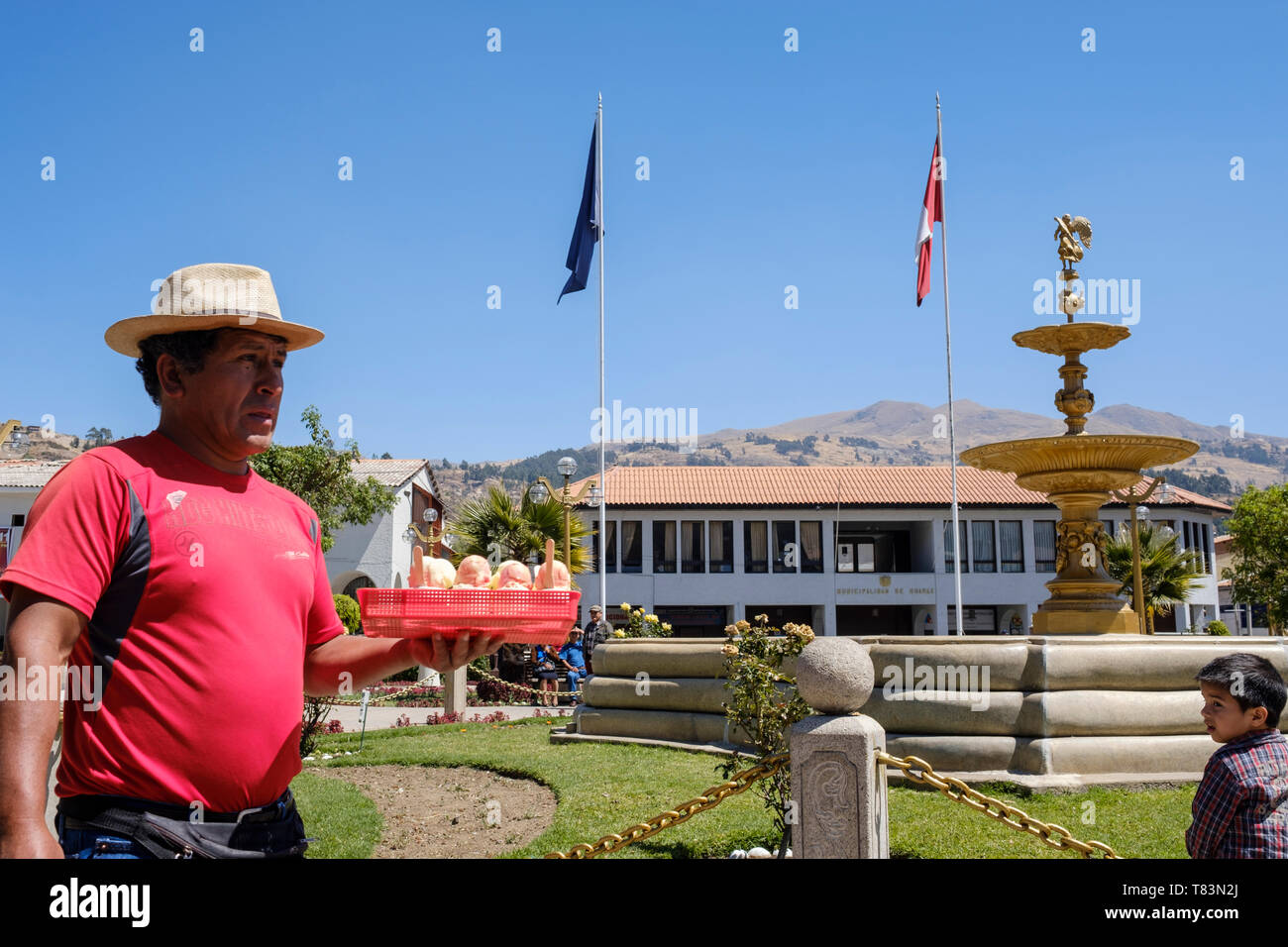 Little boy looking at the ice cream hawker at Plaza de Armas or Main Square of Huaraz, Ancash Region, Peru Stock Photo