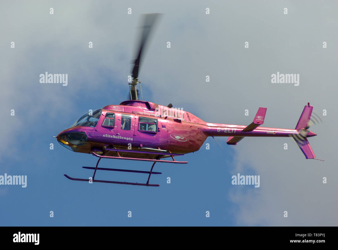 Bell 206 Longranger helicopter G-ELIT of Elite Helicopters (Henfield Lodge Aviation) flying. Civilian transport helicopter. Iridescent paint scheme Stock Photo