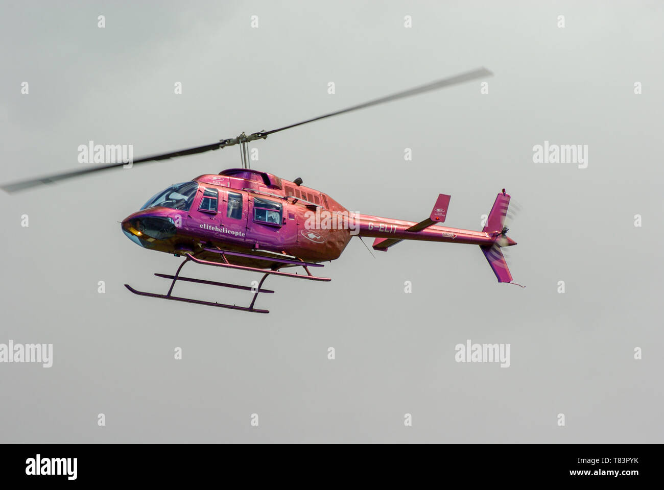 Bell 206 Longranger helicopter G-ELIT of Elite Helicopters (Henfield Lodge Aviation) flying. Civilian transport helicopter. Iridescent paint scheme Stock Photo