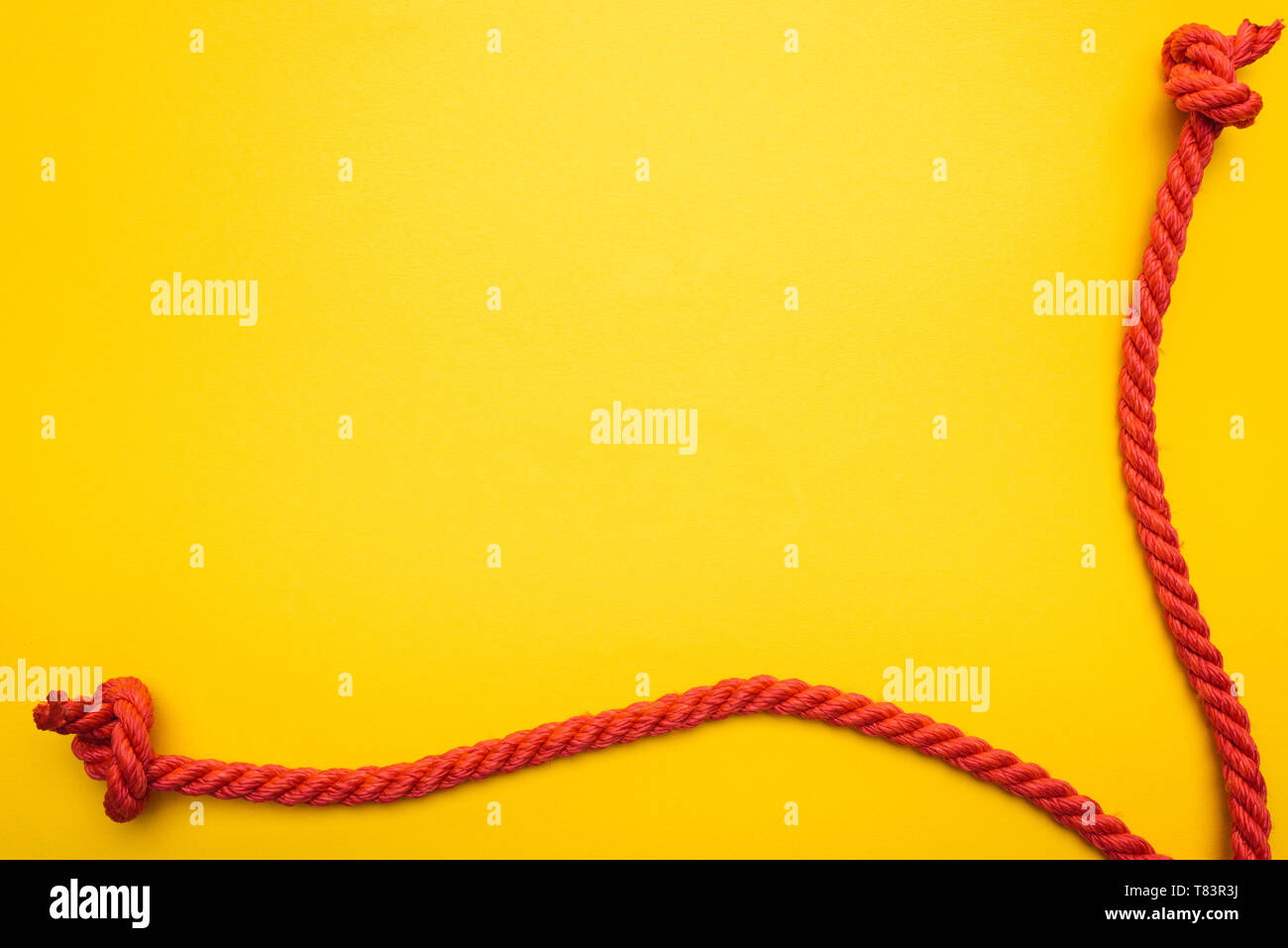 red jute ropes with knots isolated on orange Stock Photo Alamy