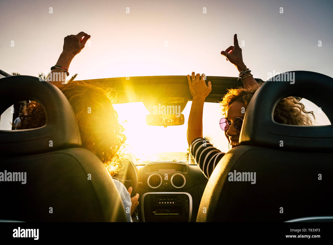 People joy and happy driving and traveling for summer holiday vacation and outdoor leisure activity with convertivle car laughing and dancing like cra Stock Photo