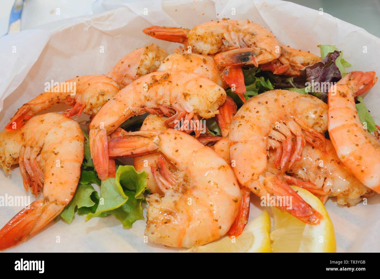 Close up of plate with delicious, mouthwatering, cooked, whole, fresh Key West Pink Shrimp with lemon slices, Key West, Florida, USA Stock Photo