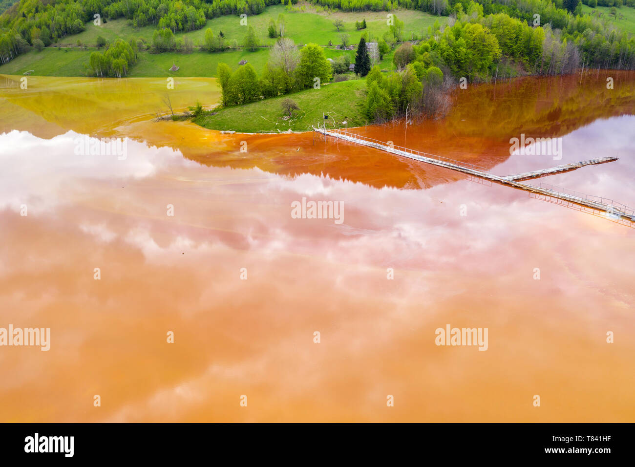 Aerial view of chemical mining waste residuals flooding into a settling