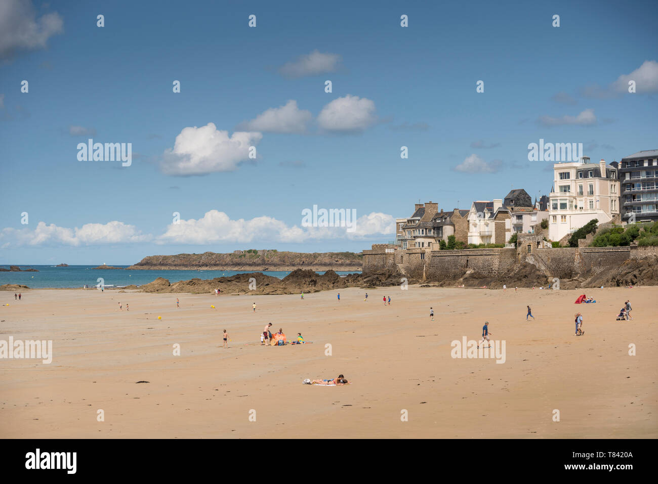 People enjoying sunshine on sandy beach of Saint Malo, Brittany, France Stock Photo
