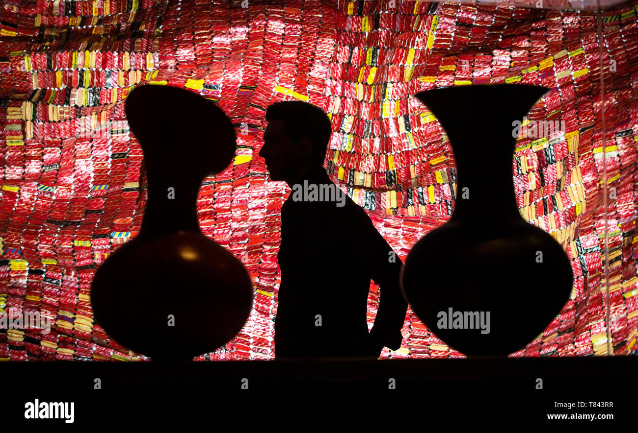 Gallery employee Ryan Johnson views an exhibition titled Magdalene