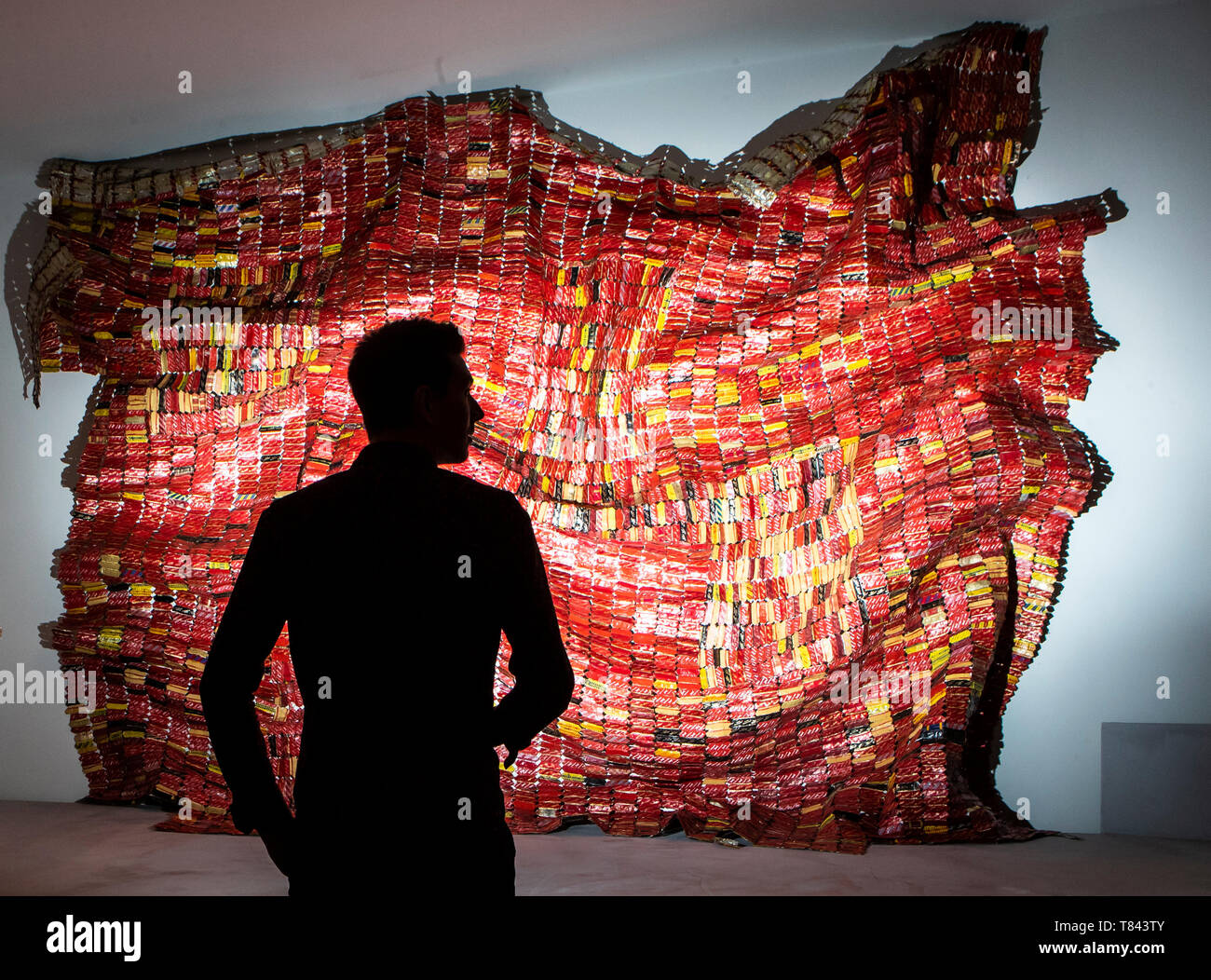 Gallery employee Ryan Johnson views an exhibition titled Magdalene