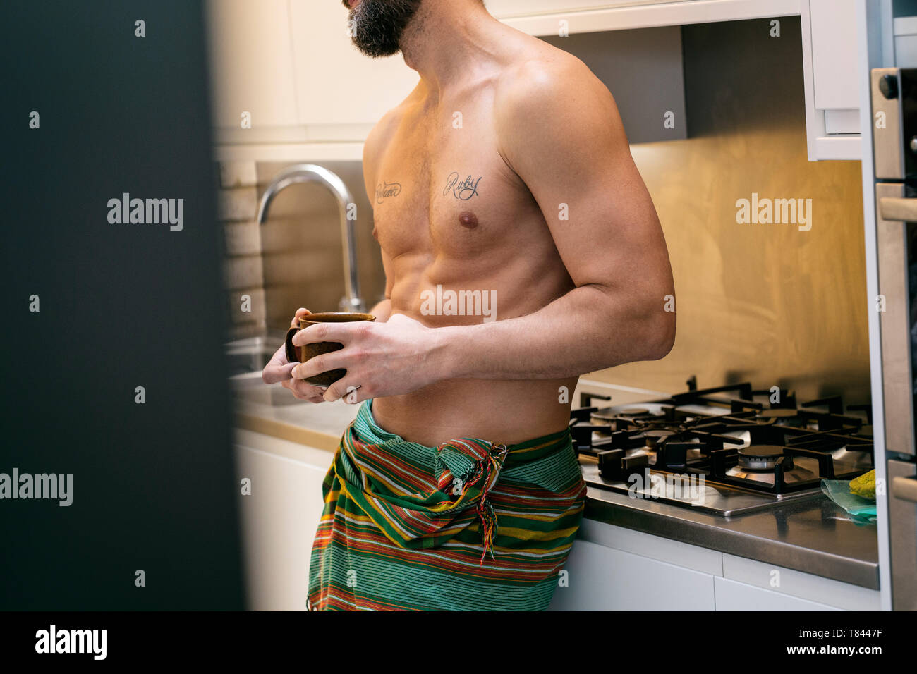 Hipster man having coffee in kitchen Stock Photo