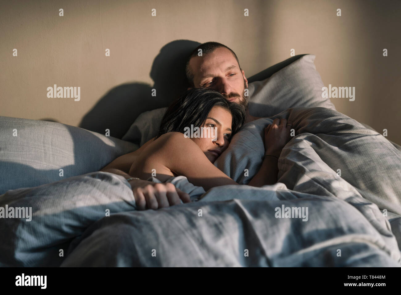 Hipster couple resting in bed Stock Photo