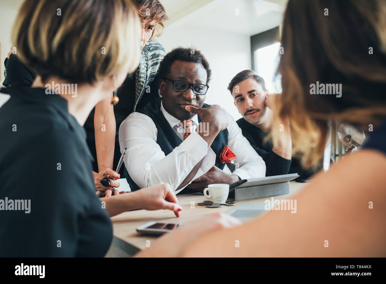 Businessmen and businesswomen having discussion in loft office Stock Photo