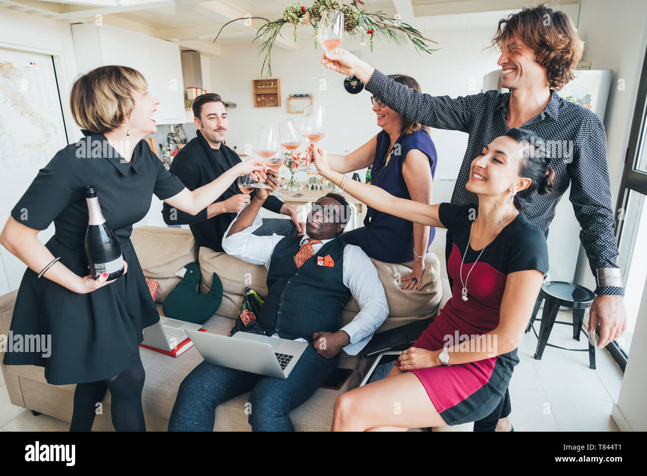 Businessmen and businesswomen toasting wine in loft office Stock Photo