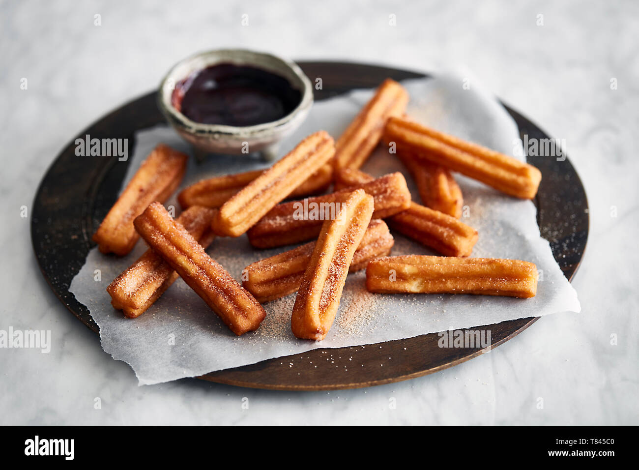 Churros and chocolate dipping Stock Photo
