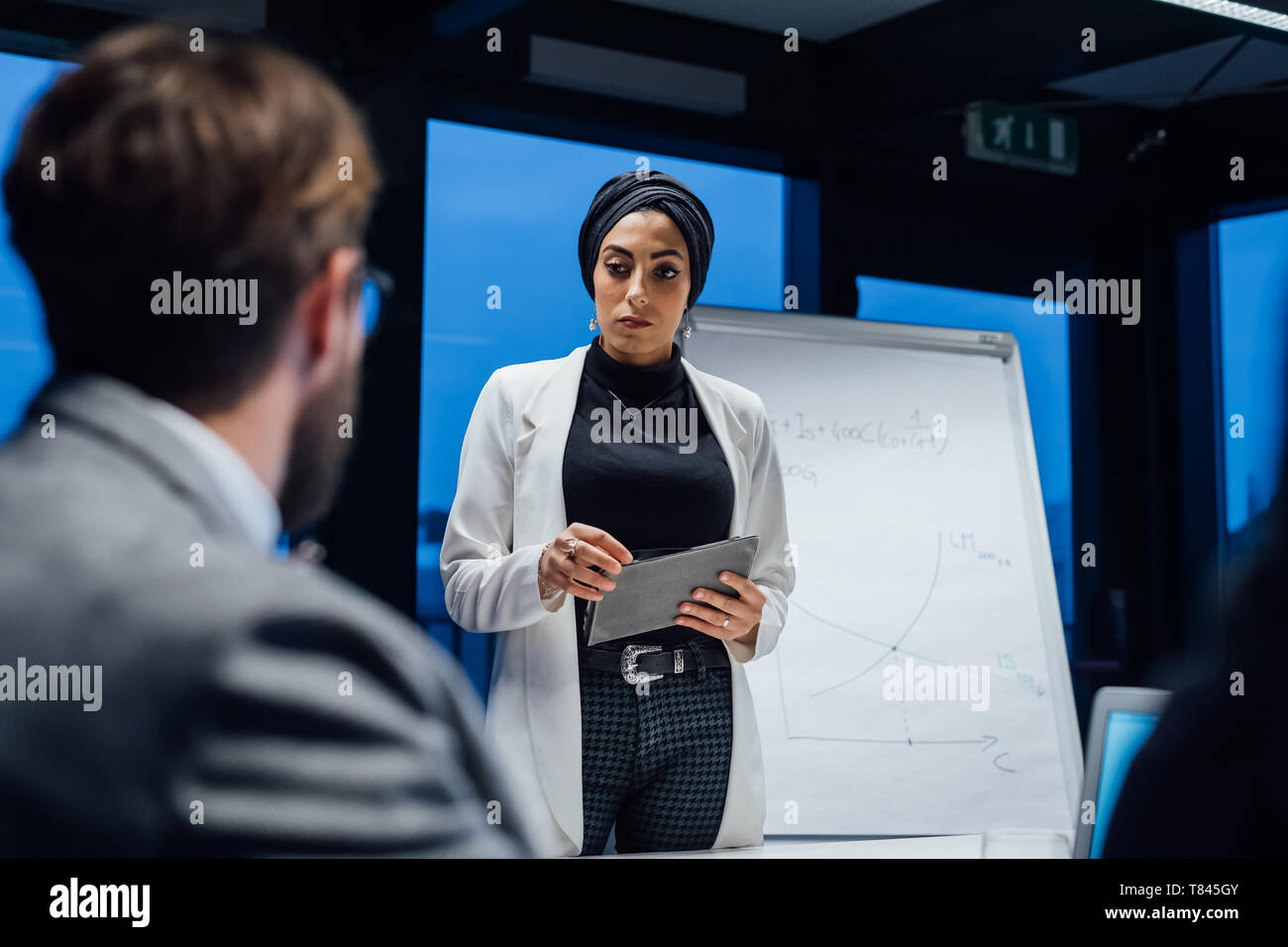 Businesswoman using digital tablet during office presentation Stock Photo