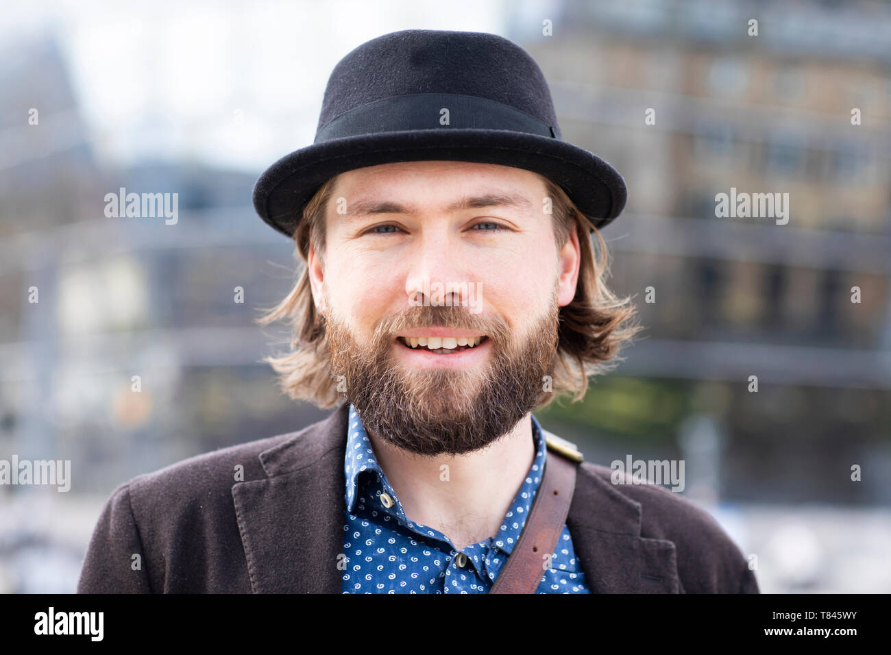Man in trilby on city street, close up portrait Stock Photo