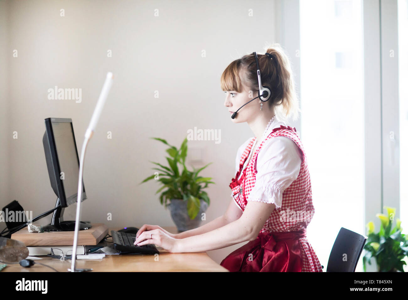 Woman using computer in home office Stock Photo